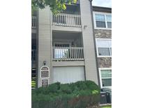 Condo building with balconies, stone accents and landscaped bushes at 9160 E Arbor Cir # F, Englewood, CO 80111