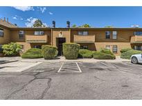 Cozy two-story townhouse featuring assigned parking, mature landscaping, and private entrances at 3315 S Ammons St # 111, Lakewood, CO 80227