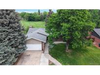 Charming single-Gathering home featuring a two-car garage and beautiful landscaping, perfect for suburban living at 8663 E Davies Ave, Centennial, CO 80112