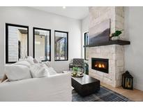 Bright living room featuring a stone fireplace and large windows at 21 Washington Ave, Golden, CO 80403