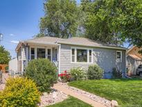 Charming single-story home with well-maintained lawn, lush landscaping, and a welcoming walkway at 3645 S Fox St, Englewood, CO 80110