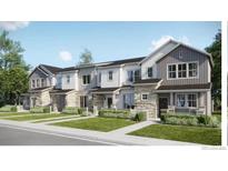 Charming townhomes showcase a blend of stone and siding, complemented by well-manicured lawns at 6688 E 149Th Ave # 2, Thornton, CO 80602
