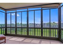 Bright sunroom featuring large windows with beautiful views of the lush greenery and blue skies at 14050 E Linvale Pl # 601, Aurora, CO 80014