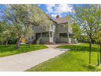 Charming two-story home with a well-manicured lawn, mature trees, and inviting front porch at 7996 Bradburn Blvd, Westminster, CO 80030