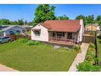 Charming brick home featuring a well-manicured lawn and a cozy, covered front porch at 4268 S Delaware St, Englewood, CO 80110