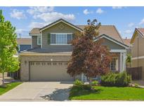 Charming two-story home features a two-car garage, brick accents, and well-maintained landscaping at 7342 S Mobile St, Aurora, CO 80016