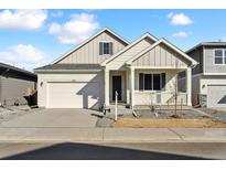 Charming single-Gathering home boasts a two-car garage and covered front porch, perfect for enjoying the outdoors at 240 Lark Sparrow Way, Bennett, CO 80102