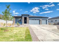 Charming single-story home with a three-car garage, stone accents, and a well-manicured lawn at 39210 Anthony St, Elizabeth, CO 80107