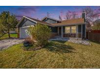 Charming home with a well-manicured lawn, rock garden, and inviting front porch at 482 Southpark Rd, Highlands Ranch, CO 80126
