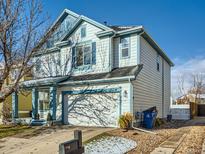 Two-story house with blue accents, attached garage, and landscaped yard at 5224 Mt Arapaho Cir, Frederick, CO 80504