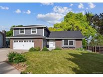 Charming two-story home with a well-maintained lawn, brick accents, a new roof and attached garage at 6545 S Balsam Ct, Littleton, CO 80123