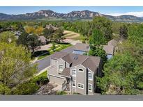 Stunning home featuring a two-car garage, gray siding, and mountain views at 5523 Stonewall Pl, Boulder, CO 80303
