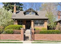 Charming brick home with landscaped front yard and gated entrance, showcasing curb appeal and architectural details at 789 S Gaylord St, Denver, CO 80209
