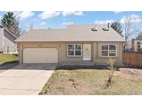 Ranch-style home featuring a one-car garage, neutral color palette, and a well-maintained lawn at 1603 S Flanders Way, Aurora, CO 80017