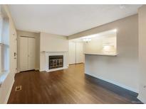 Inviting living room with hardwood floors and a cozy fireplace at 6705 S Field St # 803, Littleton, CO 80128