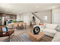 Bright, open-concept living space features hardwood floors and modern decor at 20802 E 66Th Ave, Aurora, CO 80019