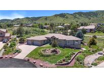 Beautiful single-story home with a three-car garage and meticulously landscaped front yard at 10950 Elk Horn Run, Littleton, CO 80125