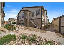 Attractive multi-Gathering home with neutral siding, landscaped with rocks and garden plants at 4474 Copeland Cir # 102, Highlands Ranch, CO 80126