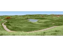 Beautiful golf course view with lush green fairways and a scenic pond at 5603 Twilight Way, Parker, CO 80134