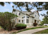 Charming home exterior with lush landscaping, large windows, and stone accents at 805 Summer Hawk Dr # 100, Longmont, CO 80504
