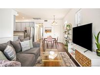 Bright living room featuring modern furniture, a stylish rug, and ample space for relaxation and entertainment at 2773 Roslyn St, Denver, CO 80238