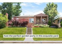 Charming brick home with a manicured front yard and inviting porch, perfect for suburban living at 5044 W Moncrieff Pl, Denver, CO 80212