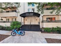 Charming building entrance featuring an awning, double doors, and landscaped surroundings, plus a bike at 1365 Columbine St # 403, Denver, CO 80206