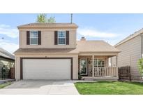 Charming two-story home featuring a well-maintained front yard and an attached two-car garage at 4534 Nepal St, Denver, CO 80249