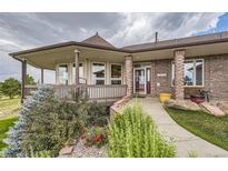 Inviting front entrance with a charming porch and well-maintained landscaping at 2981 Rock Cir, Elizabeth, CO 80107
