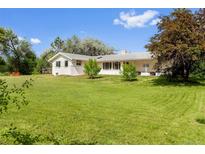 Charming ranch-style home with a well-manicured lawn, mature trees and a peaceful outdoor setting at 7313 S Boulder Rd, Boulder, CO 80303