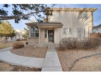 Charming two-story home with brick and vinyl siding, featuring a welcoming front porch and landscaped front yard at 2062 S Xenia Way, Denver, CO 80231