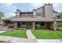 Charming multi-story home with well-maintained lawn, brick accents, and inviting entryway at 10652 W Florida Ave # D, Lakewood, CO 80232