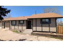 Charming tan home with green trim and a well-maintained front yard under a clear blue sky at 4710 E Louisiana Ave, Denver, CO 80246