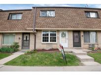 Charming townhouse exterior featuring brick facade and well-maintained landscaping at 13043 W 20Th Ave, Golden, CO 80401