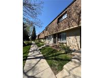 Charming brick townhomes featuring well-maintained landscaping and inviting pathways at 13043 W 20Th Ave, Golden, CO 80401