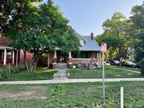 Charming brick home featuring a well-maintained front yard and covered porch at 1731 E 25Th Ave, Denver, CO 80205