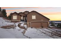 Charming home featuring an attached garage, a stone staircase, and picturesque mountain views at 13084 Deer Ridge Way, Larkspur, CO 80118