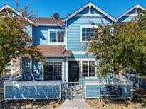 Charming blue two-story townhome with a small fenced yard and well-manicured landscaping at 2550 S Cutters Cir # 105, Castle Rock, CO 80108