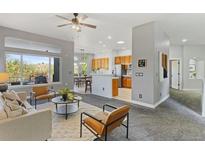 Open-concept living room with views, modern furniture, and a seamless flow to the kitchen at 828 Rabbit Run Dr, Golden, CO 80401