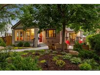 Charming home featuring a well-maintained front yard and landscaped garden at 840 S Gaylord St, Denver, CO 80209
