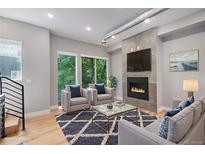 Bright living room features a modern fireplace, large windows, and stylish furnishings at 2831 W 25Th Ave # 3, Denver, CO 80211