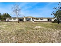 Charming single-story home with a well-maintained lawn and beautiful curb appeal at 5128 S Greenwood Dr, Evergreen, CO 80439