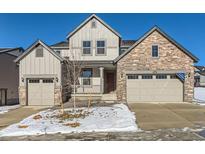 Two-story house with stone and siding exterior, two car garage, and covered porch at 15566 W Beloit Ave, Morrison, CO 80465