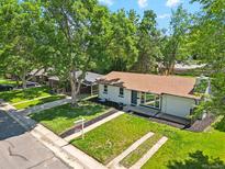 Charming single story home with a well-manicured lawn and mature shade trees at 4140 S Inca St, Englewood, CO 80110