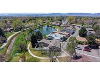 Beautiful aerial view of the community with green spaces, a pond, walking path, and mountain views at 39 S Scott Dr, Broomfield, CO 80020