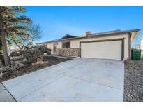 Charming single-story home with a two car garage and a well-maintained front yard at 6147 Dunraven, Golden, CO 80403