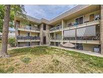 Multi-level condo building featuring balconies, brick accents, and well-maintained landscaping at 4653 S Lowell Blvd # E, Denver, CO 80236