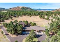 Picturesque home with attached garage nestled among towering pines with mountain views at 3842 Estates Cir, Larkspur, CO 80118