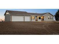 Ranch-style home featuring an attached two-car garage, neutral siding, and a well-maintained lawn at 44011 Morning Star Ct, Elizabeth, CO 80107