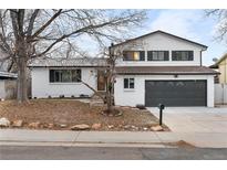 Charming home with a well-manicured front yard, showcasing its inviting curb appeal at 9565 W Lake Pl, Littleton, CO 80123